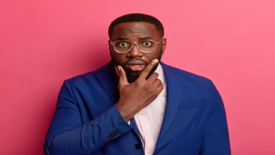successful-black-male-entrepreneur-looks-shocked-camera-holds-chin-wears-formal-blue-suit-has-speechless-look